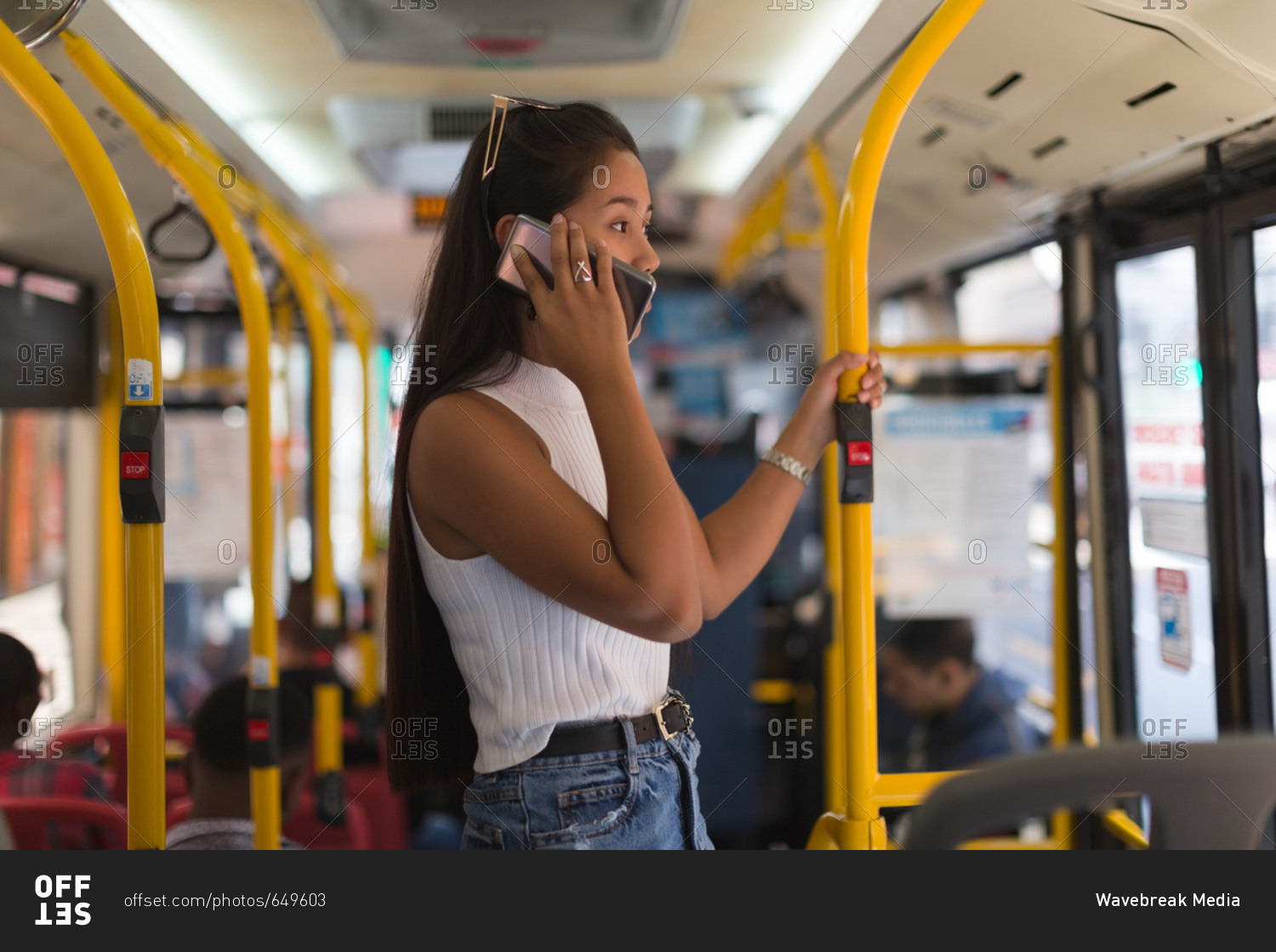 Teenage girl talking on mobile phone in the bus