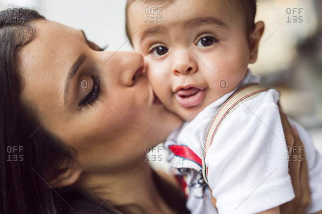 Mother kissing baby son (6-11 months)