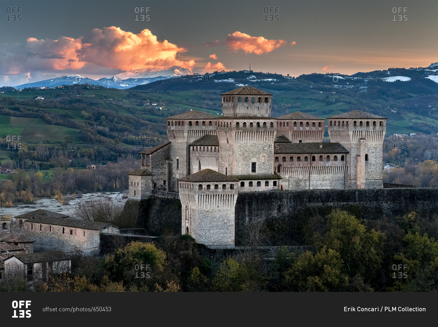 Torrechiara castle at twilight and in the background the Cusna mount, Langhirano, Emilia Romagna, Italy