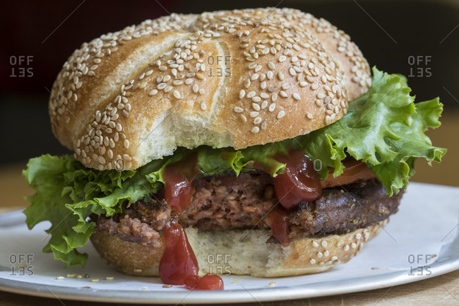 Vegetarian burger with a bite taken off