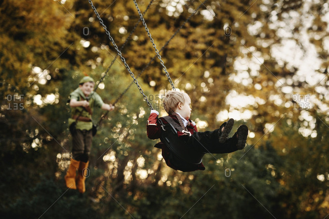 Boys swinging in costumes