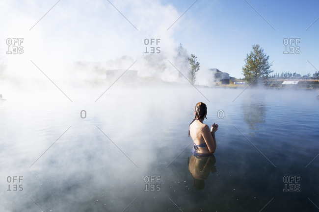 A woman bathing in The Secret Lagoon in Iceland