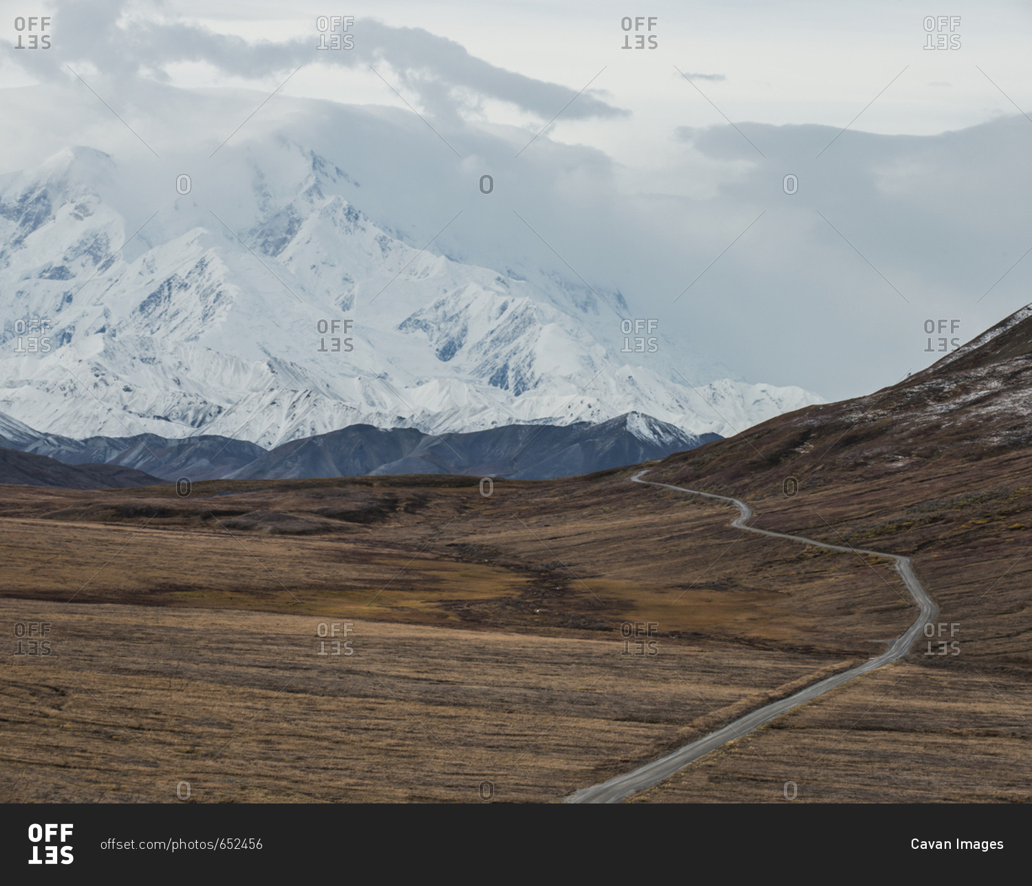 High angle view of road amidst field against snowcapped mountains at Denali National Park and Preserve during foggy weather