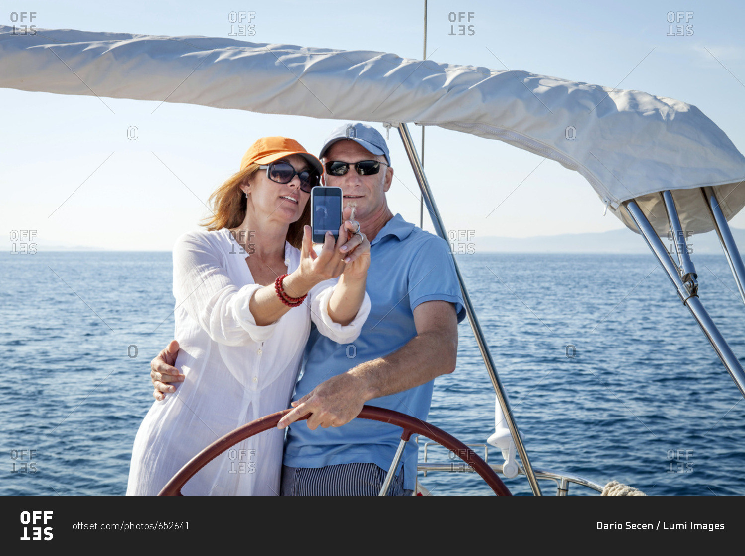 Mature couple sailing together, taking pictures, Adriatic Sea, Croatia