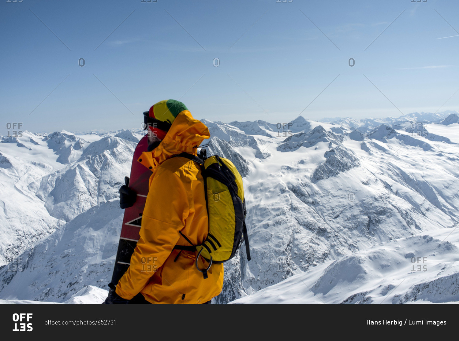 Back country skier taking a look at mountain range, European Alps, Tyrol, Austria