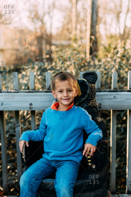 Boy sitting on bear seat at zoo