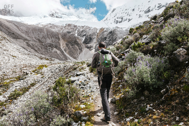 Woman hiker with backpack hiking in Cordillera Blanca, Peru, A