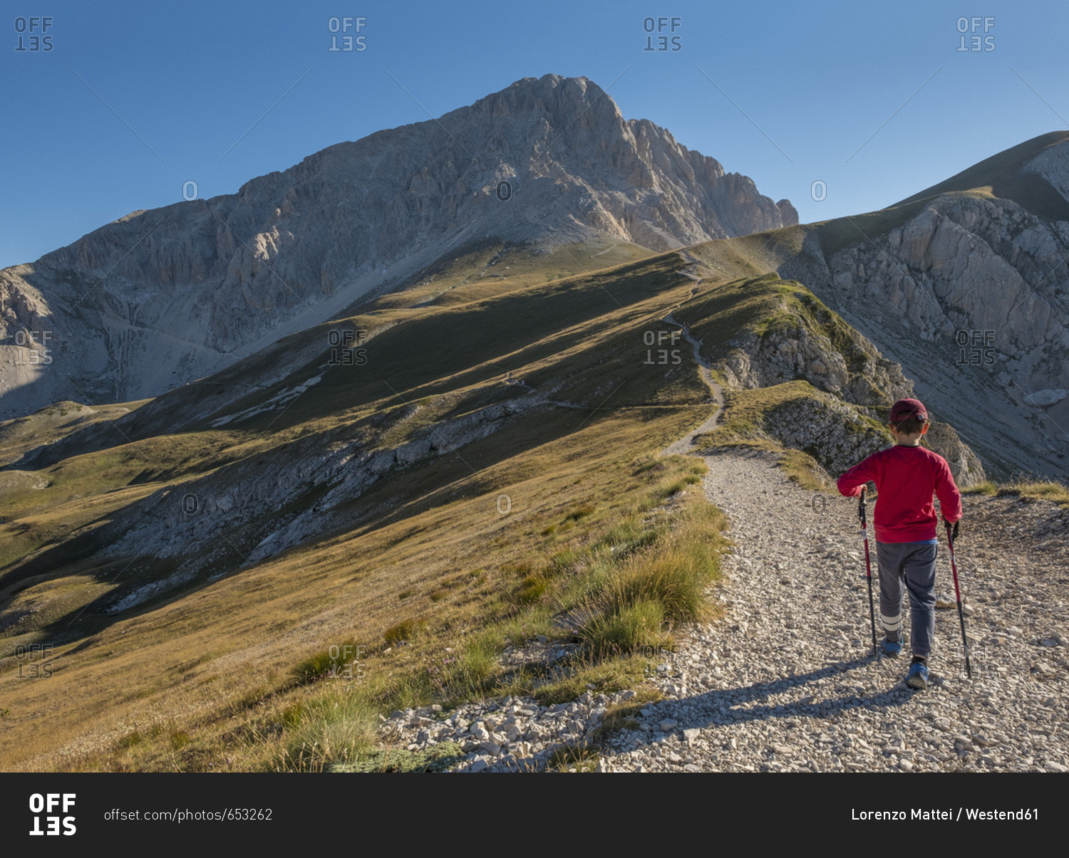 Italy- Abruzzo- Gran Sasso e Monti della Laga National Park- boy on hiking trail of Corno Grande