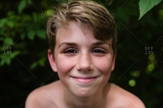 Smiling boy with freckles in black and white