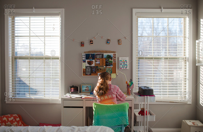 Girl Working At Desk Between Two Windows Stock Photo Offset