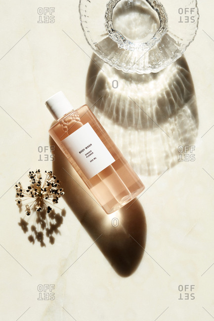 Liquid body wash beside glass dish