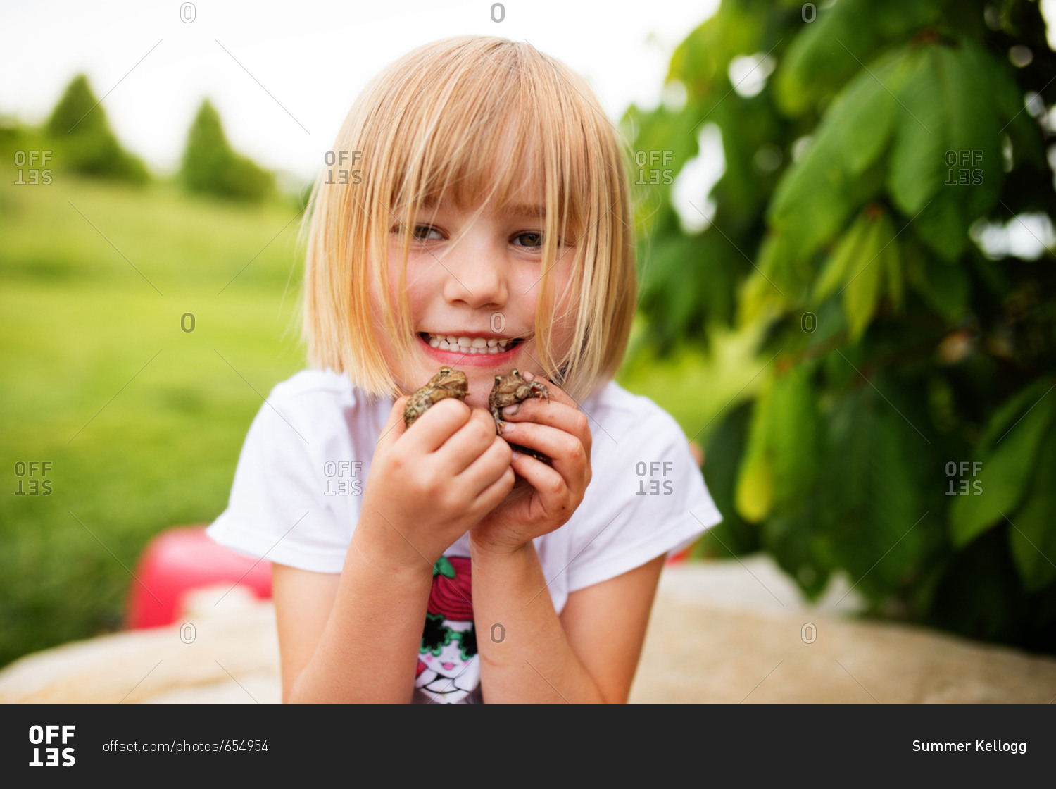 Girl holding toads