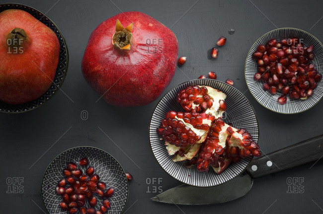 Pomegranate and pomegranate seeds in bowl