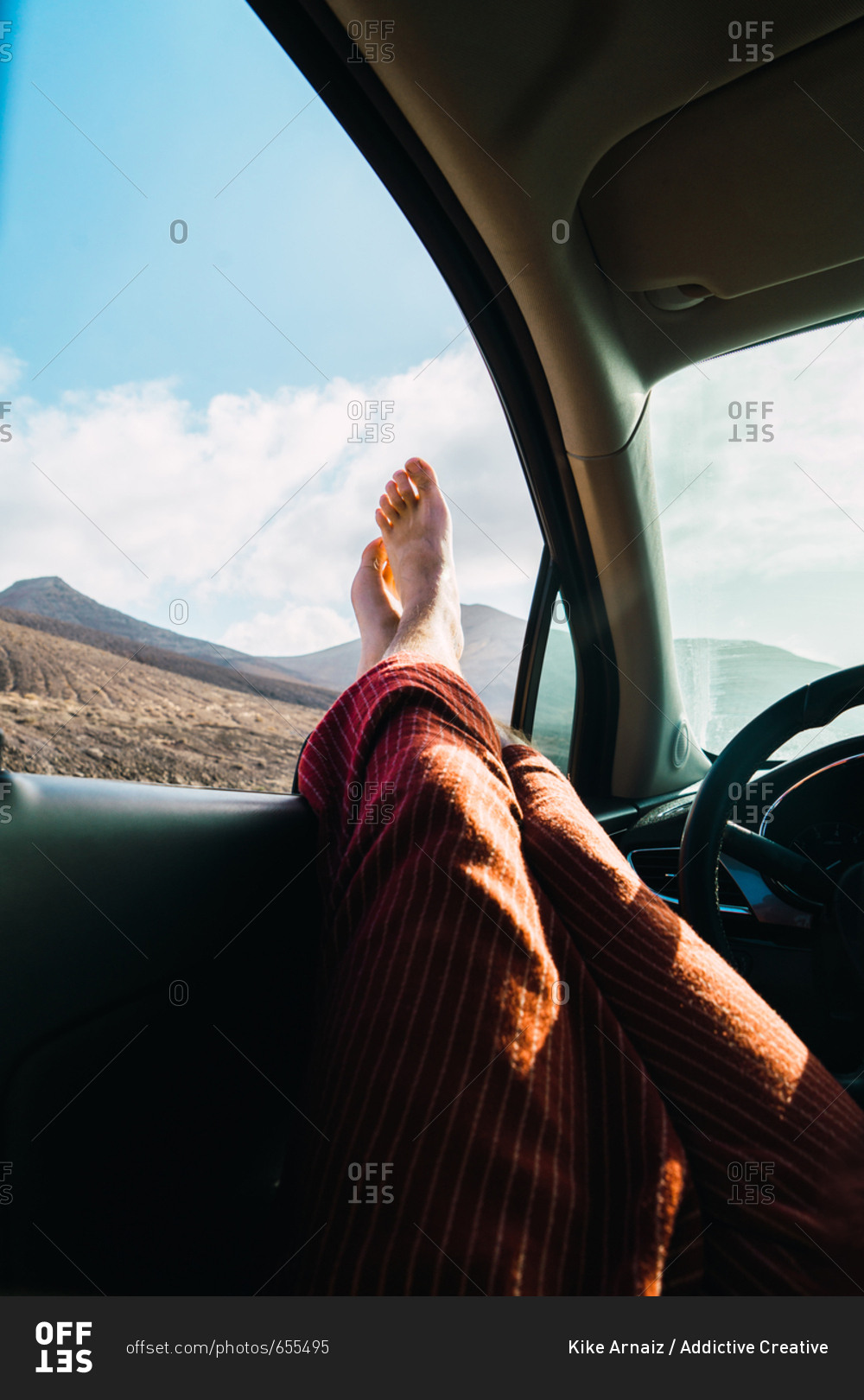 Crop man relaxing in car while traveling