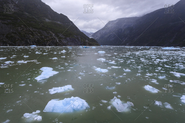 Heavy ice near face of South Sawyer Glacier, misty conditions, mountain backdrop, Tracy Arm Fjord, Alaska, United States of America, North America