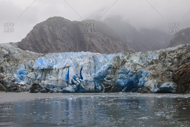 Blue ice face and floating ice, Sawyer Glacier and mountains, misty conditions, Stikine Icefield, Tracy Arm Fjord, Alaska, United States of America, North America