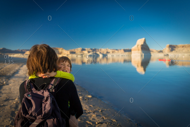 Child Laughing and Hugging His Mother on Lone Rock Beach at Lake Powell