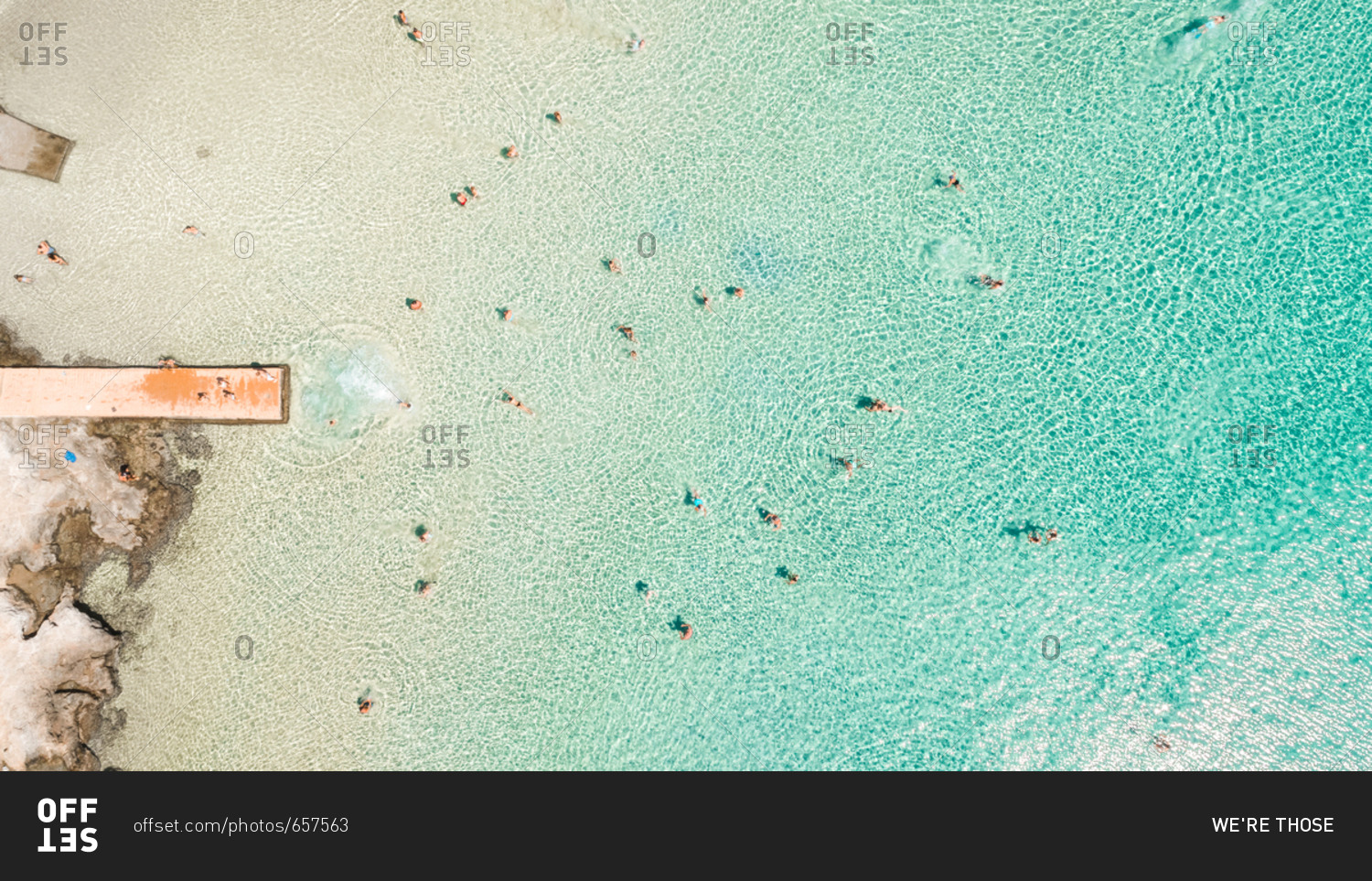 Aerial photography of people swimming in the sea of Poseidonia, Island of Syros, Greece.