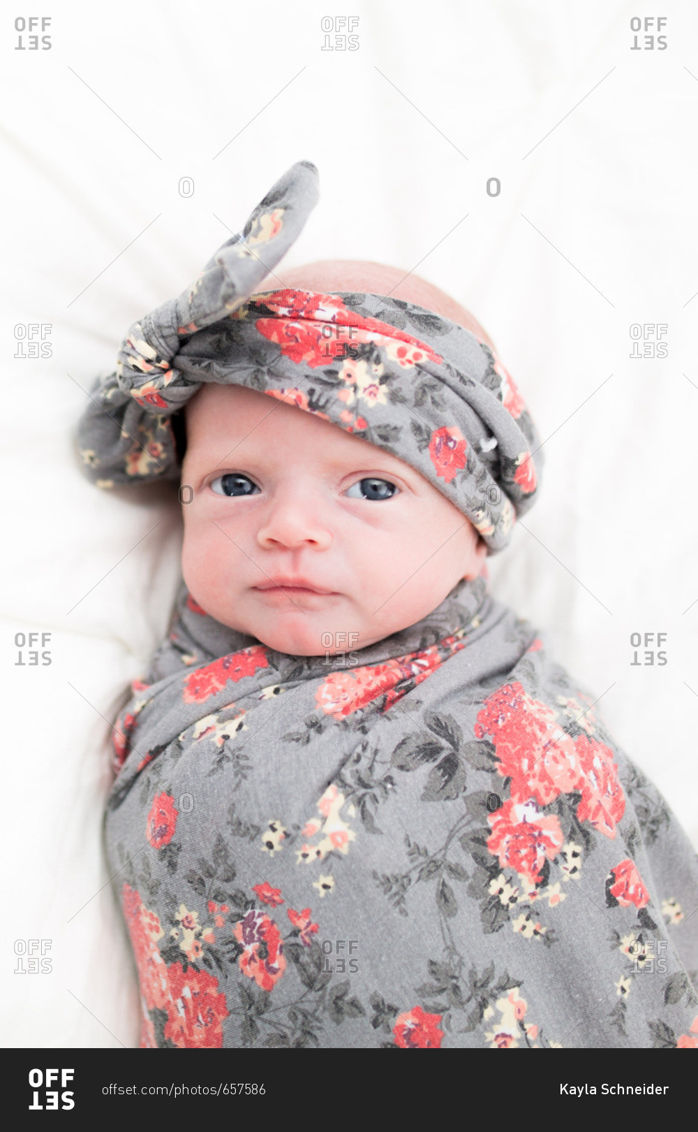 Portrait of newborn girl in swaddling clothes