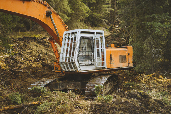 Excavator sitting on new road in forest