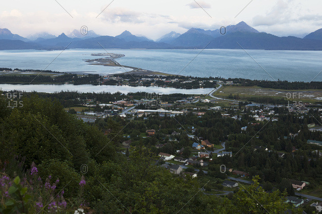 Homer Spit, Kachemak Bay And The Kenai Mountains Under A Cloudy Sky; Homer, Alaska, United States Of America