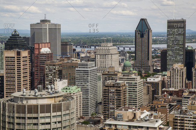 View over the city of Montreal with the downtown area, office buildings, condominiums and the river; Montreal, Quebec, Canada