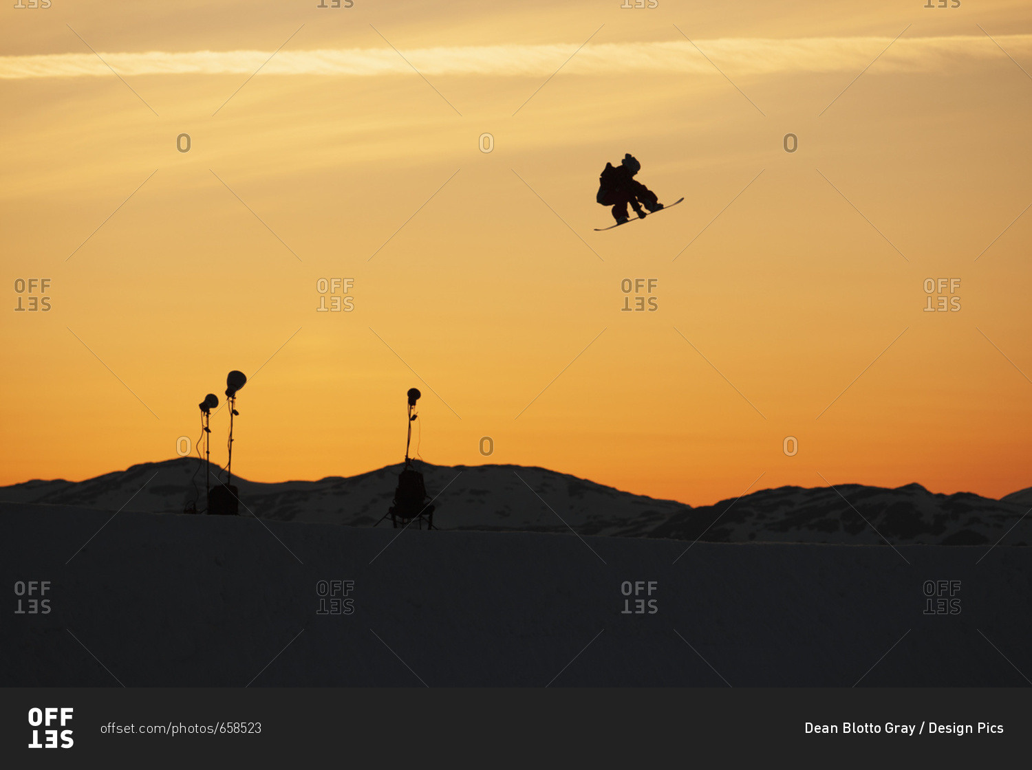 Silhouette Of A Snowboarder Jump In Mid-Air At Sunset; Norway