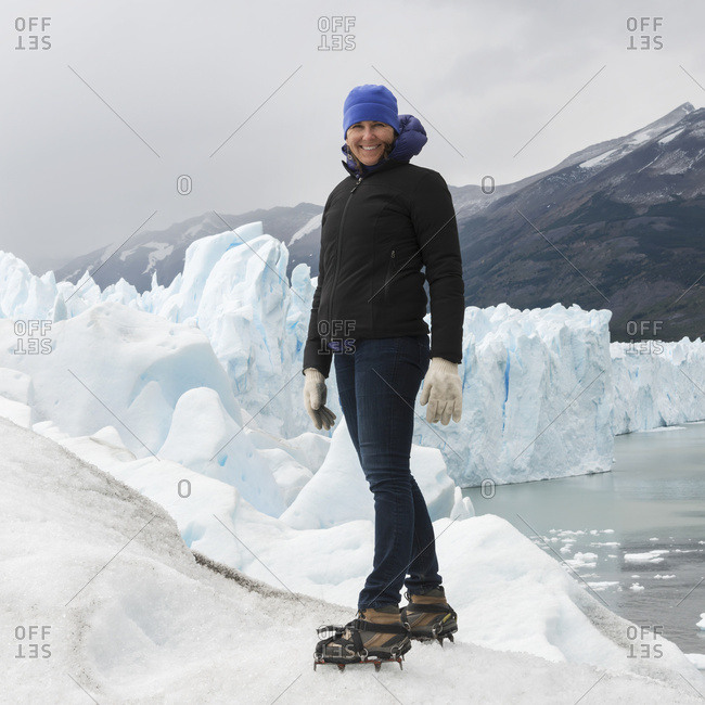 A Woman With Crampon Spikes On Her Hiking Boots On Moreno Glacier, Los Glaciares National Park; Santa Cruz Province, Argentina