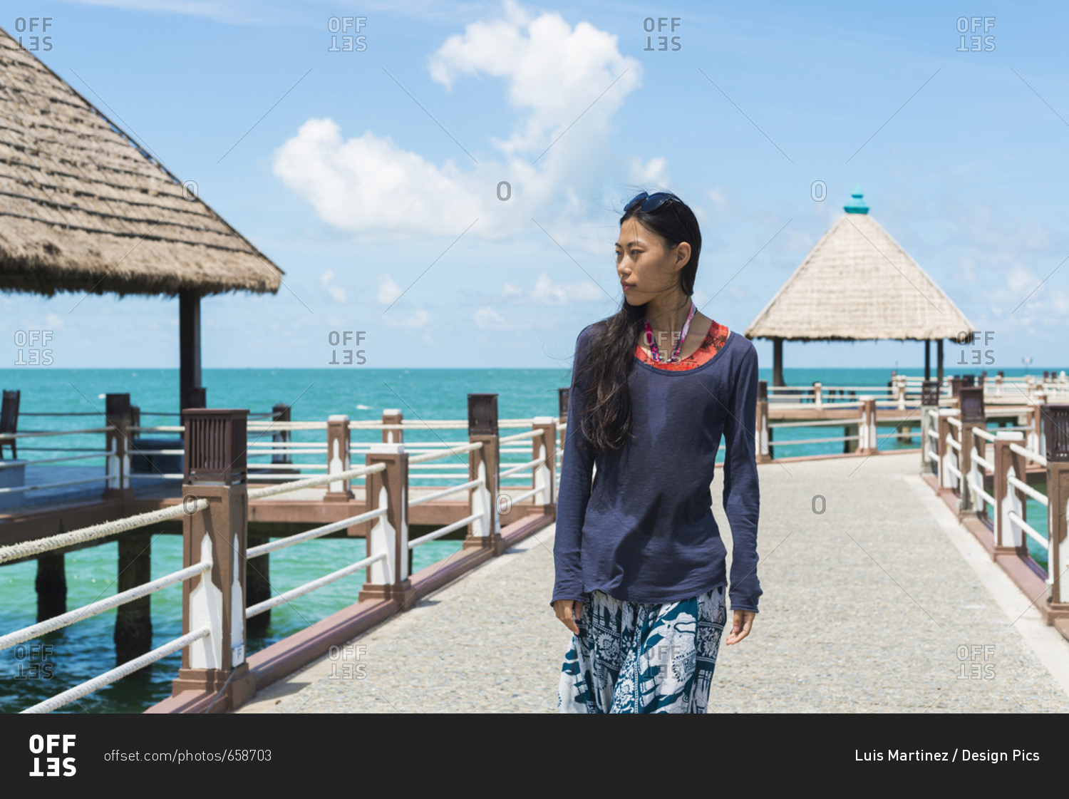 A Young Woman Walks On The Pier At Independence Beach; Sihanoukville, Cambodia