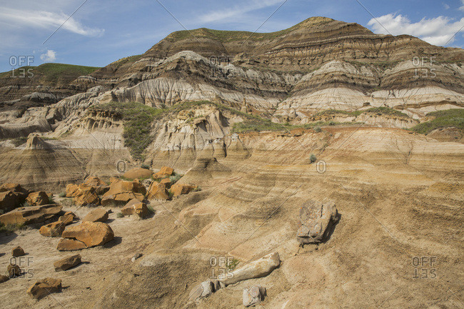 The Hillsides Around Drumheller, Alberta, With Layers Of Sedimentary Rock Creating Bands Of Color In The Landscape; Alberta, Canada