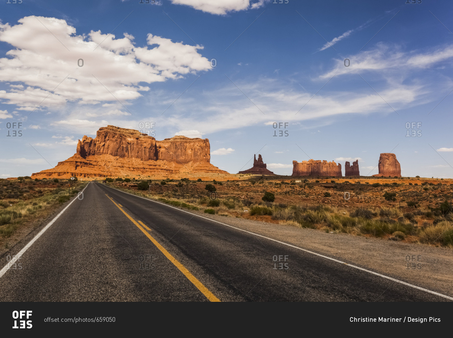 A Road Leading To Rugged Rock Formations In The Desert; Arizona, United States Of America