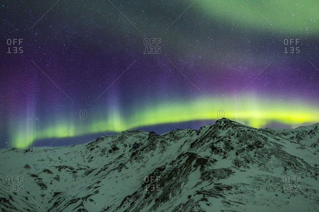 Aurora Borealis Over Mountains Within Denali National Park On A Very Cold Winter Night.  The Andromeda Galaxy Is Visible To The Left; Alaska, United States Of America