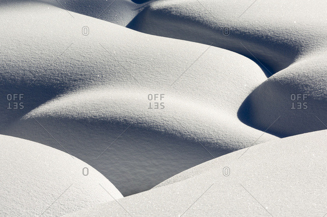 Artistic Montage Of Snow Contouring A Creek Bed With Graphic Designs Of Curving Highlights And Shadows; Lake Louise, Alberta, Canada