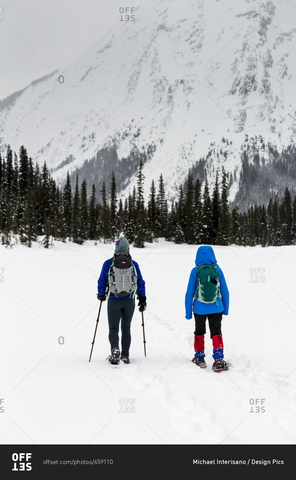 Two Women Snowshoeing In The Mountains, East Of Field; British Columbia, Canada
