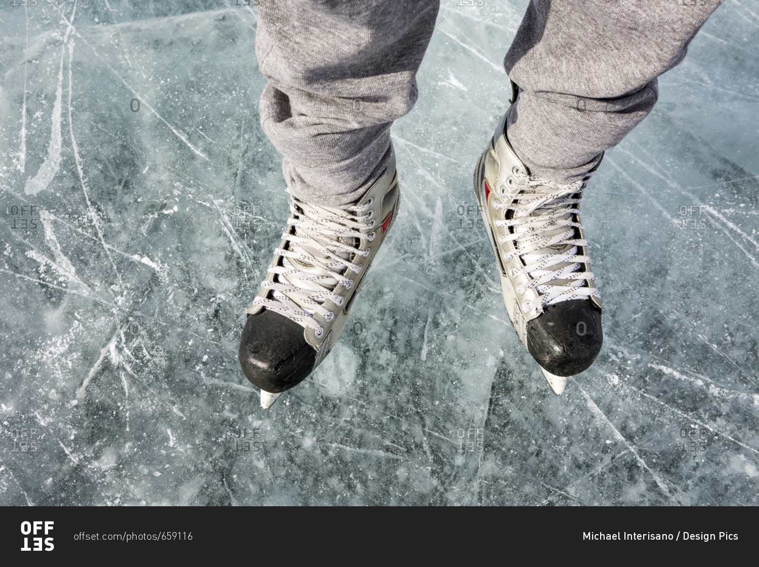 High Angle View And CloseUp Of Hockey Skates On Ice; Calgary, Alberta, Canada stock photo OFFSET