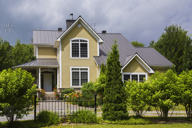 Yellow House With White Trim And Brown Metal Roof Country Cottage