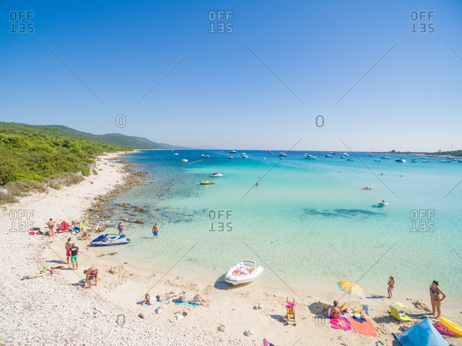 ADRIATIC COAST - 27 AUGUST 2014: Aerial view of sandy beach with tourists swimming in beautiful clear sea water