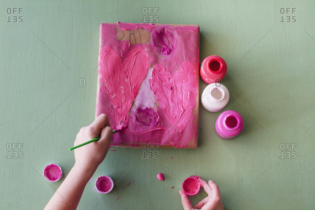 Young girl painting a valentine for Dad
