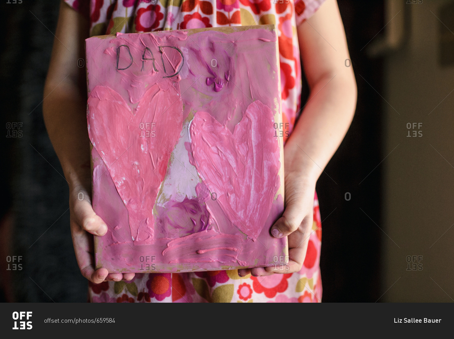 Young girl holding a valentine for Dad