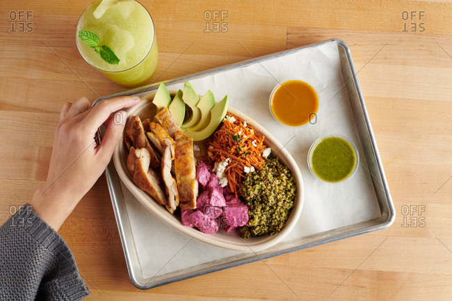 A fast casual Middle eastern meal with chicken, quinoa, and smoothie
