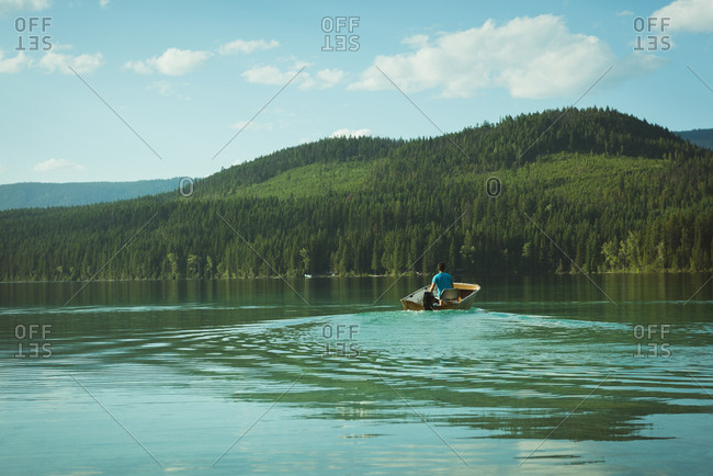 Man travelling in motorboat on a lake