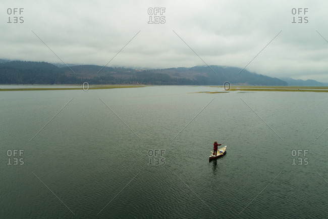 Male tourist travelling in canoe boat on a lake