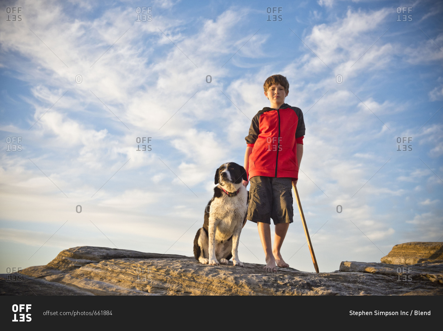 Caucasian boy hiking with dog