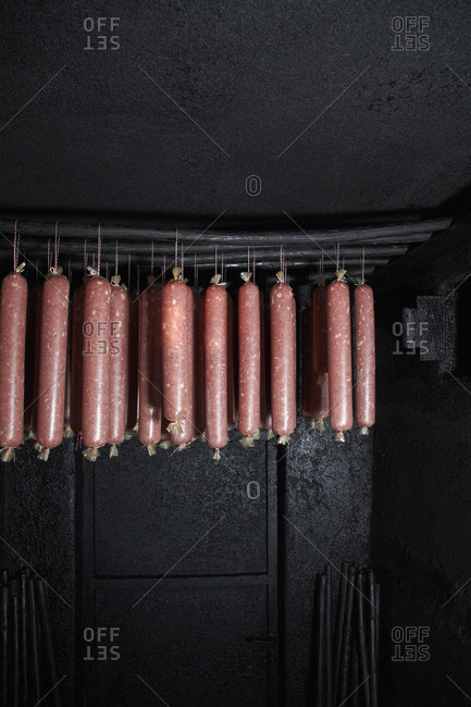 Wacholder salami, a regional specialty from Carinthia, Austria hanging in a smokehouse