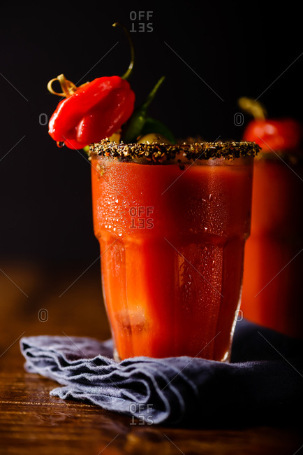 Very spicy Bloody Mary cocktails with hot peppers and olives