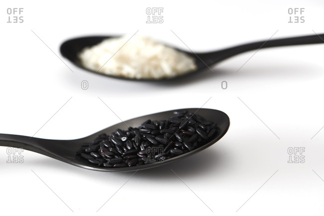 Black Indonesian heirloom rice and white Jasmine rice in closeup