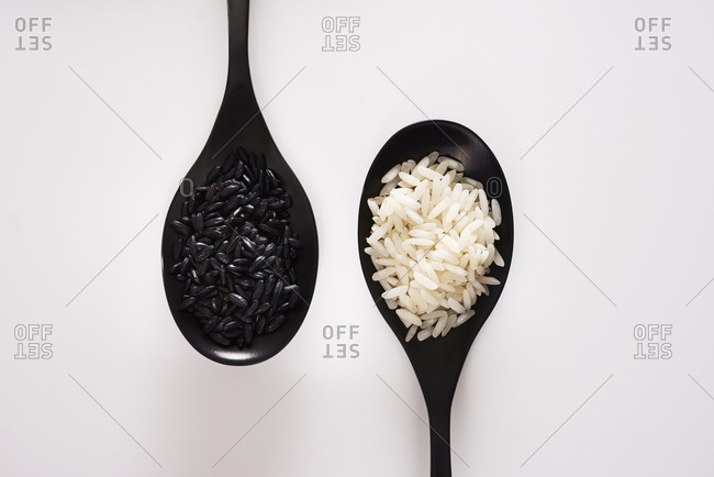 Black Indonesian heirloom rice and white Jasmine rice in closeup