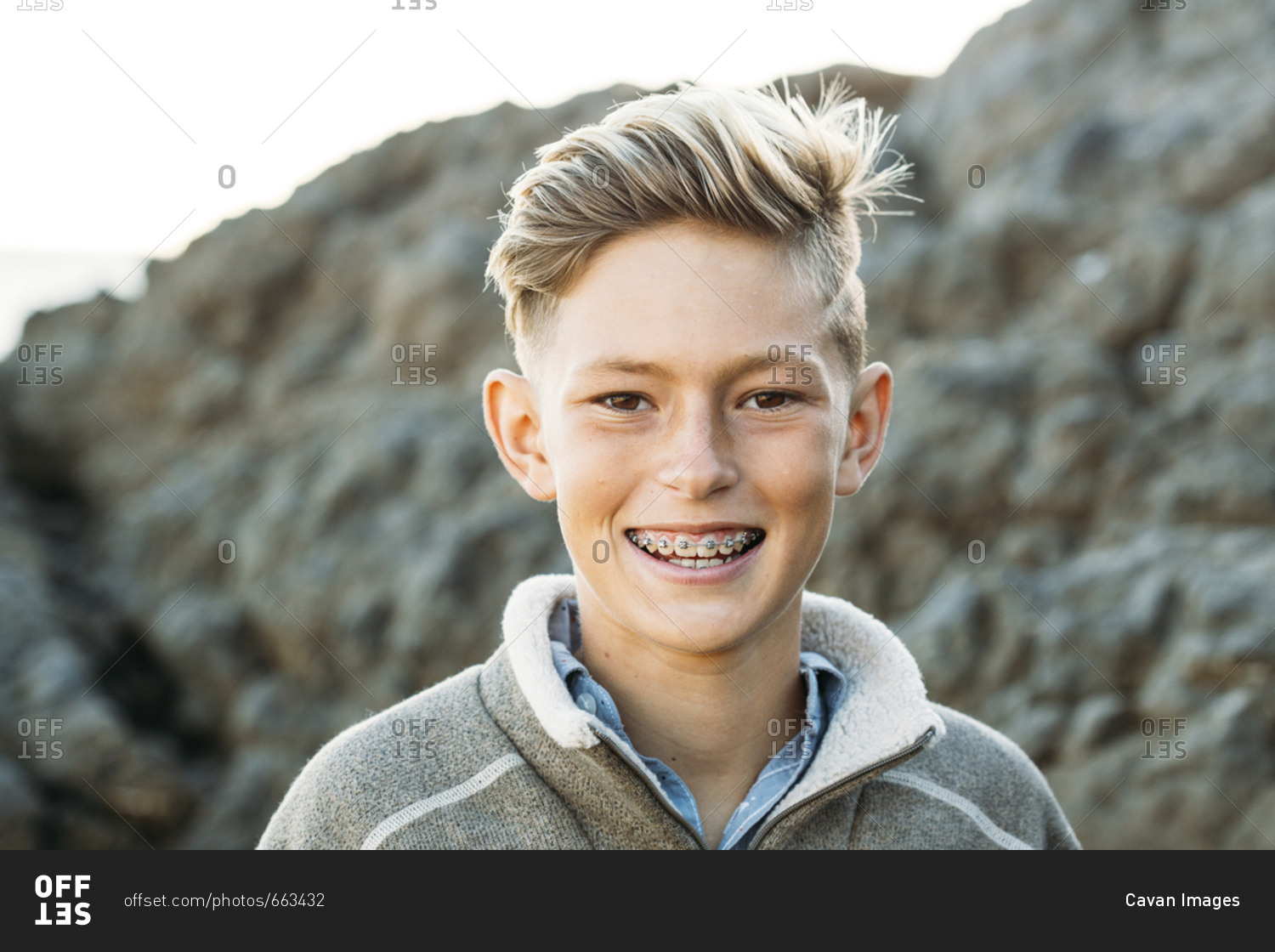 Portrait of smiling boy with braces at beach