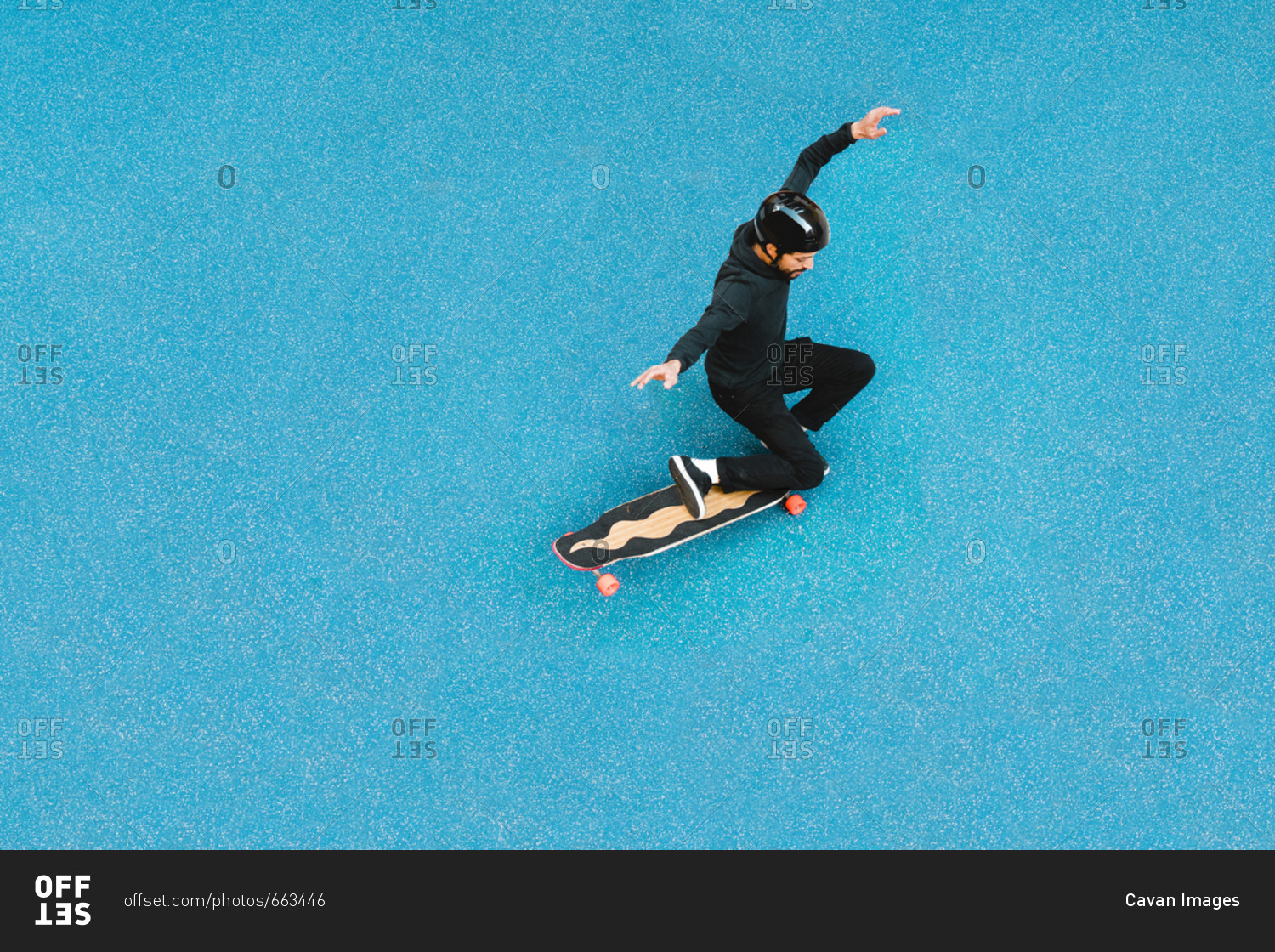 High angle view of man skateboarding on blue floor at skateboard park
