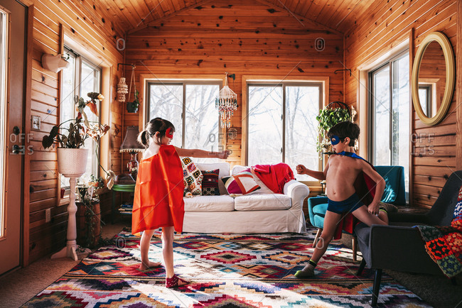 Young kids playing dressed up as super heroes